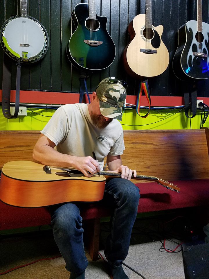 james-gee-signing-the-give-away-guitar-2
